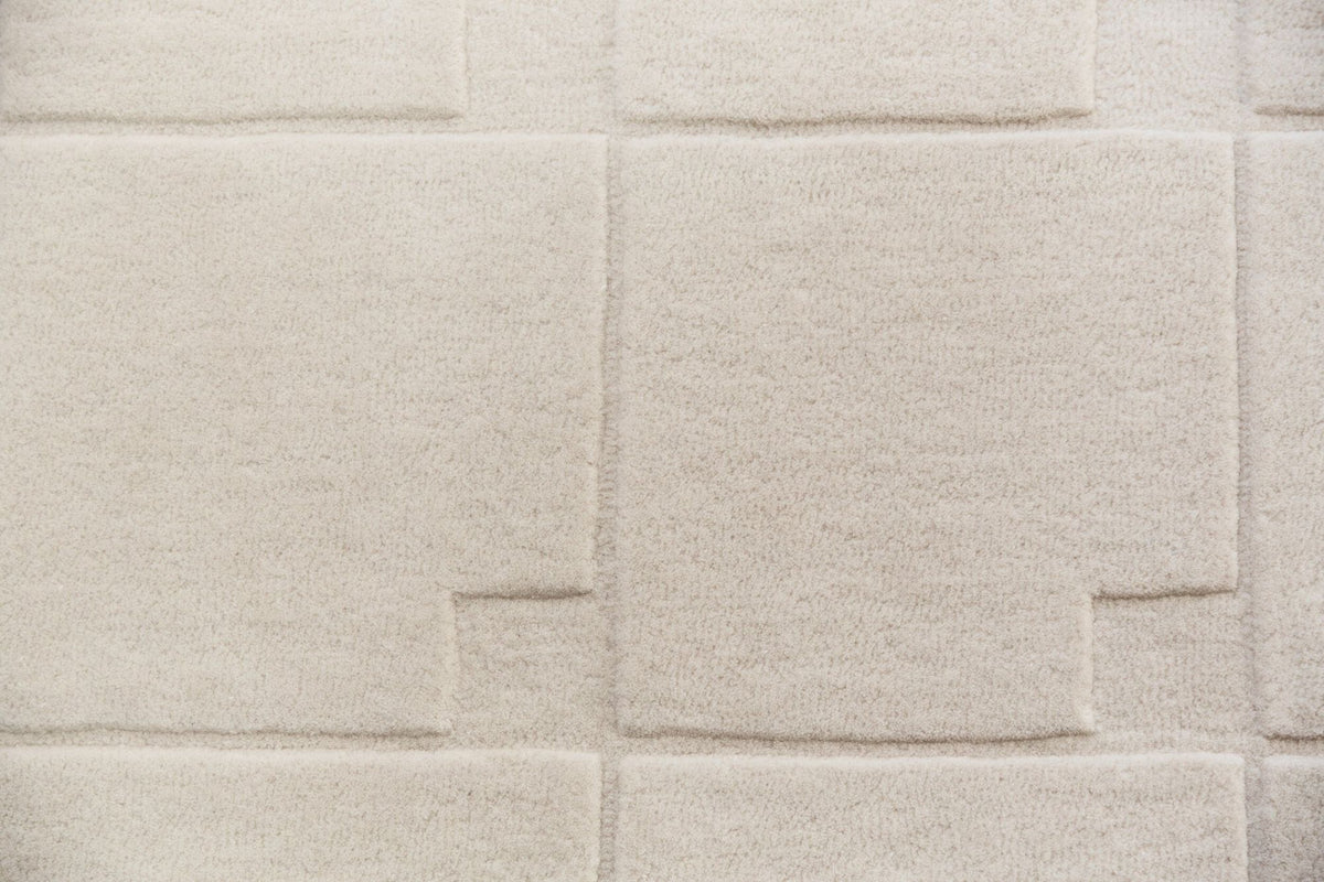 Avalanche Wool Rug close up, ivory hand tufted New Zealand wool with quiet tone on tone blocks.