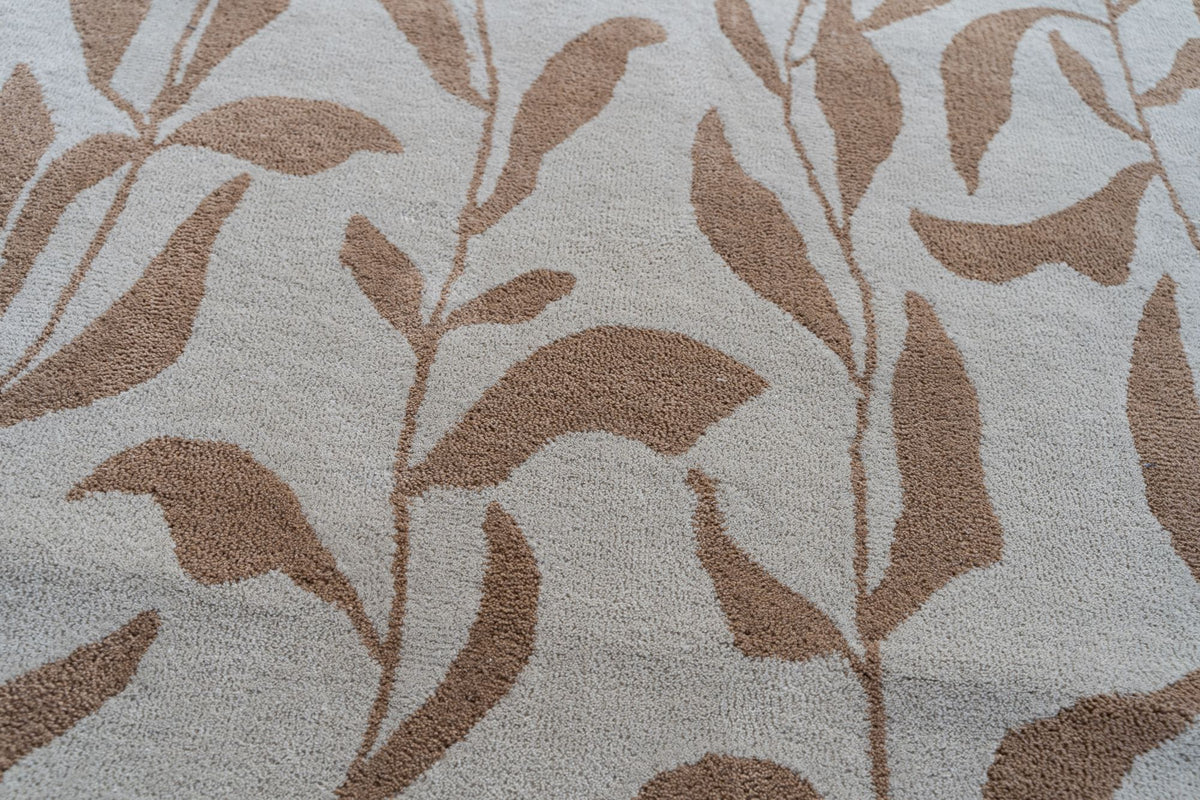Botanical Wool Rug close up, terracotta leaf sprays on ivory hand tufted New Zealand wool.