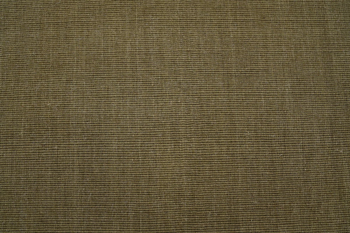 Cabra Wool & Jute Rug in Olive close up, a flat handloom weave at 7 to 8 mm that most robots cross easily.