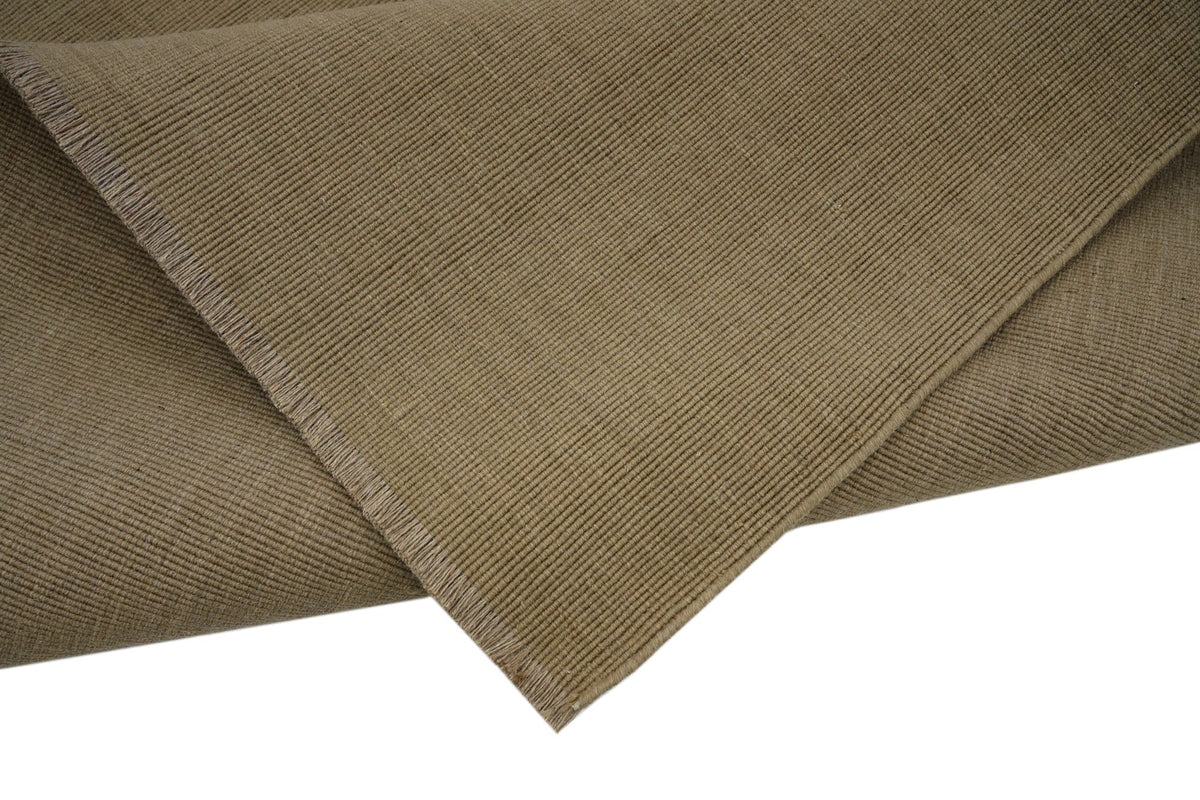 Cabra Wool & Jute Rug in Sand folded at the corner, firm handloom New Zealand wool and jute.