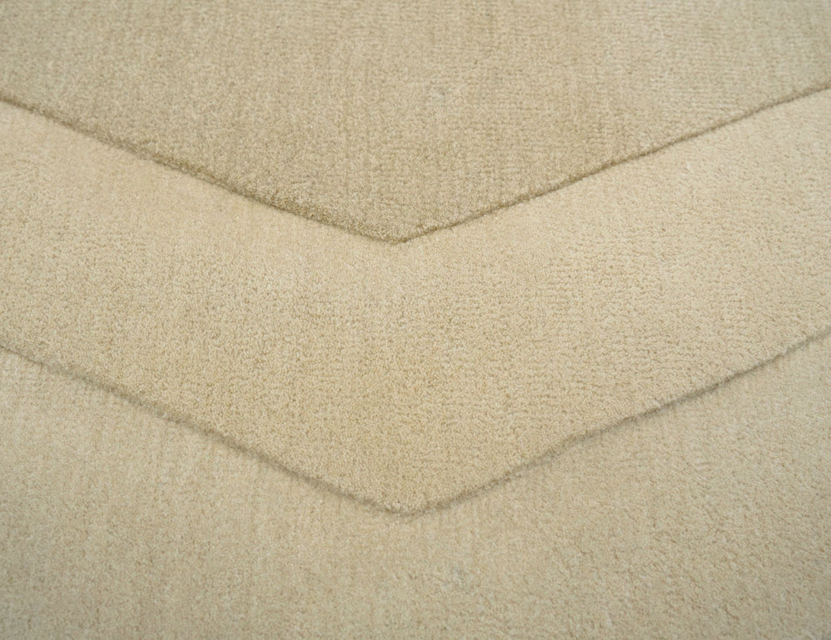 Cadence Wool Rug close up, hand tufted ivory New Zealand wool with a carved chevron groove.