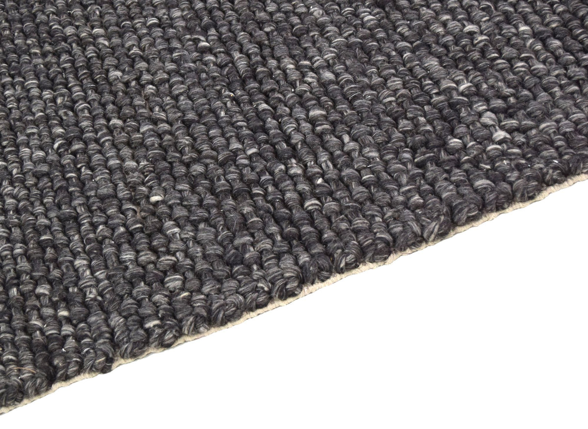 Cobble Wool Rug close up, handwoven charcoal New Zealand wool in a raised pebble weave.