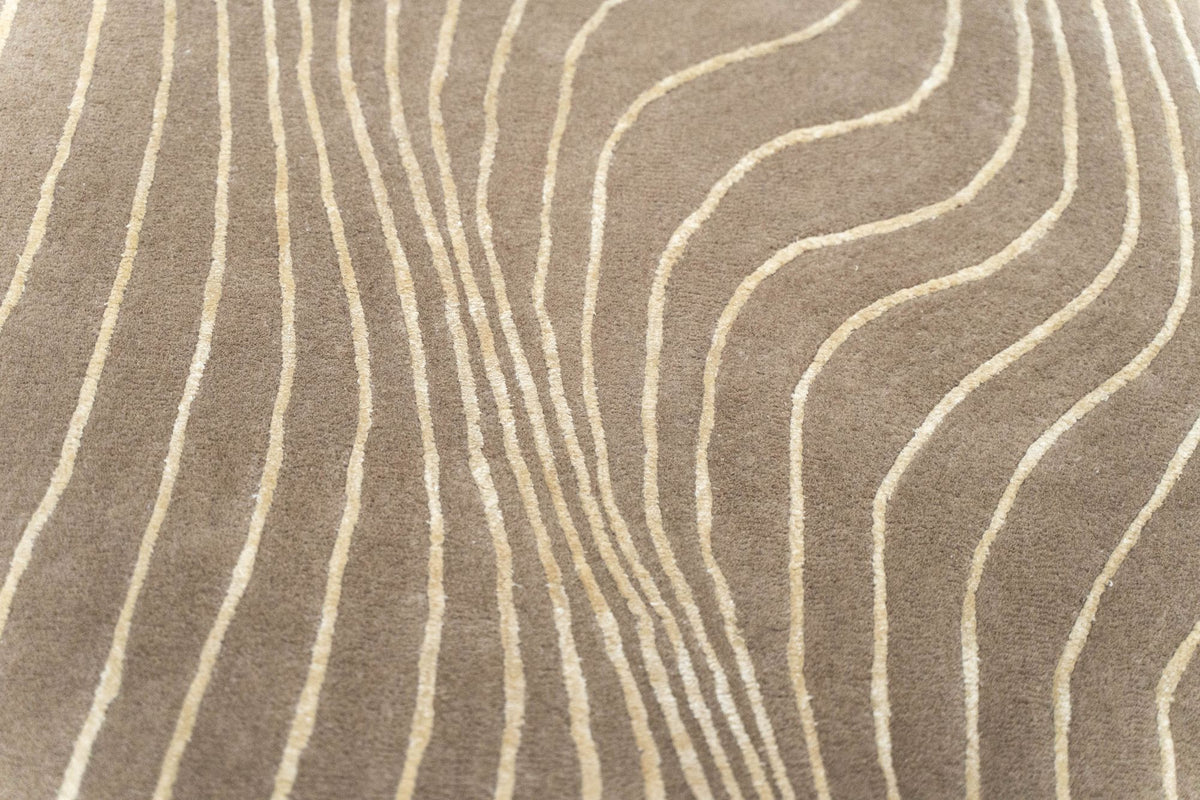 Crinkle Wool & Silk Rug close up, hand tufted wool and Botanical Silk with fine ivory lines folding across a warm tan ground.