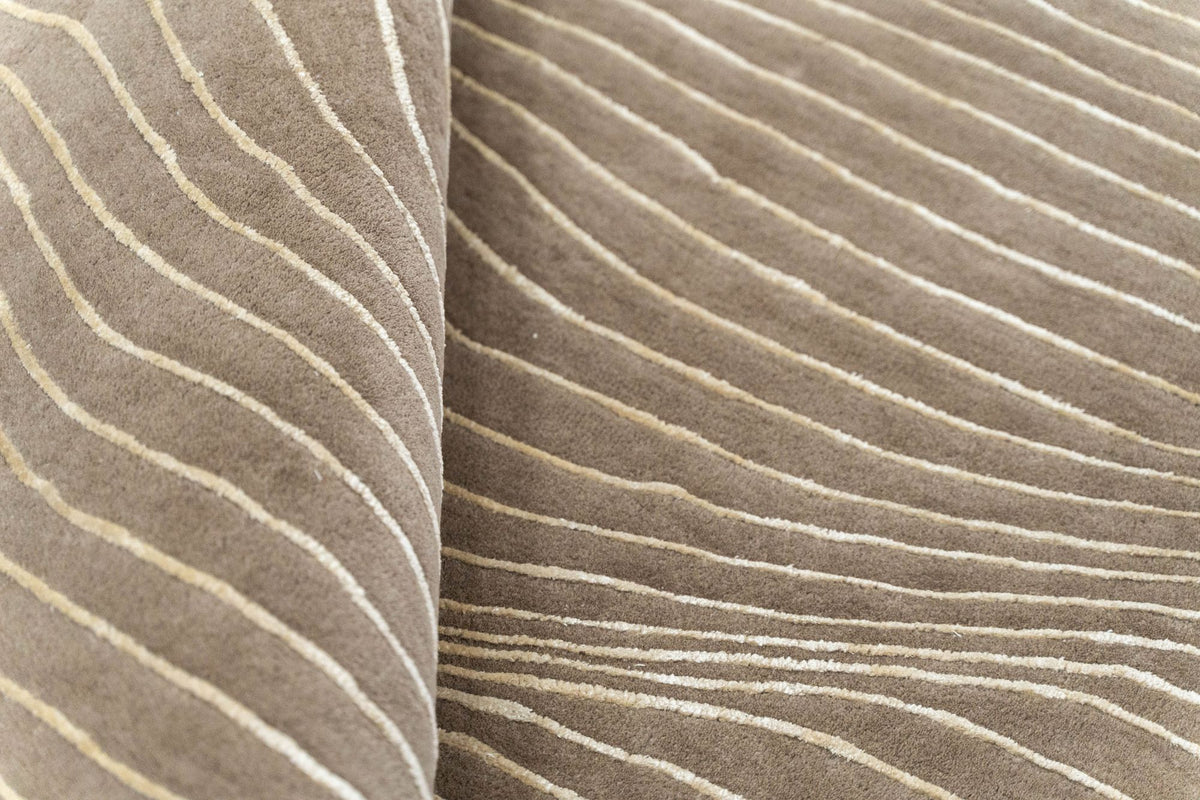 Crinkle Wool & Silk Rug close up, fine ivory ripples of Botanical Silk on a sand field of New Zealand wool.
