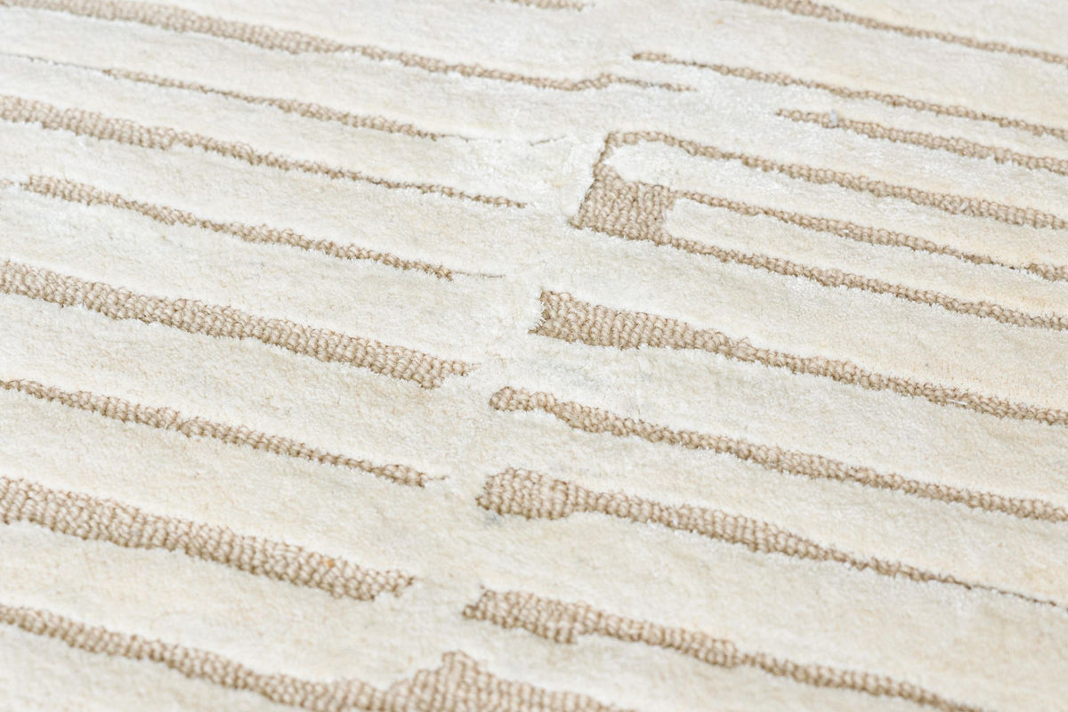 Dune Wool & Silk Rug close up, hand tufted New Zealand wool and Botanical Silk ridged in long pale bands.
