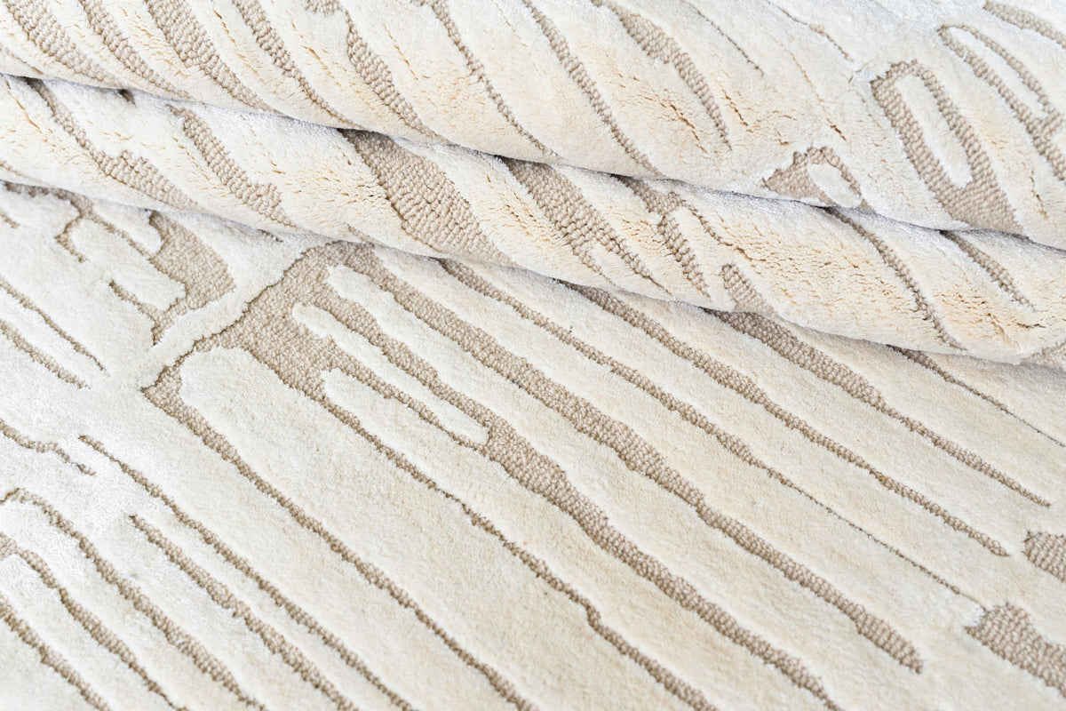 Dune Wool & Silk Rug close up, hand tufted New Zealand wool and Botanical Silk with soft sand bands on an ivory ground.