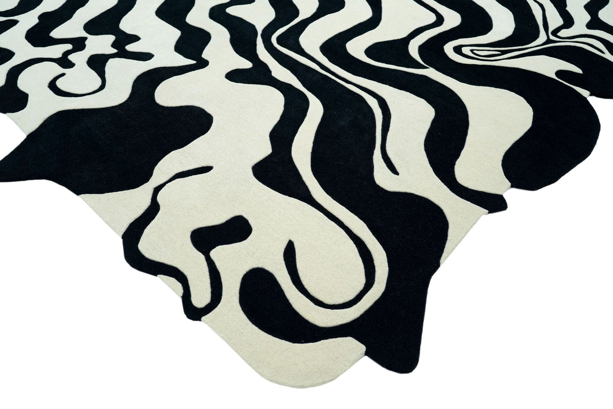 Fluid Wool Rug with a free curved outline, black and ivory hand tufted New Zealand wool in flowing bands.