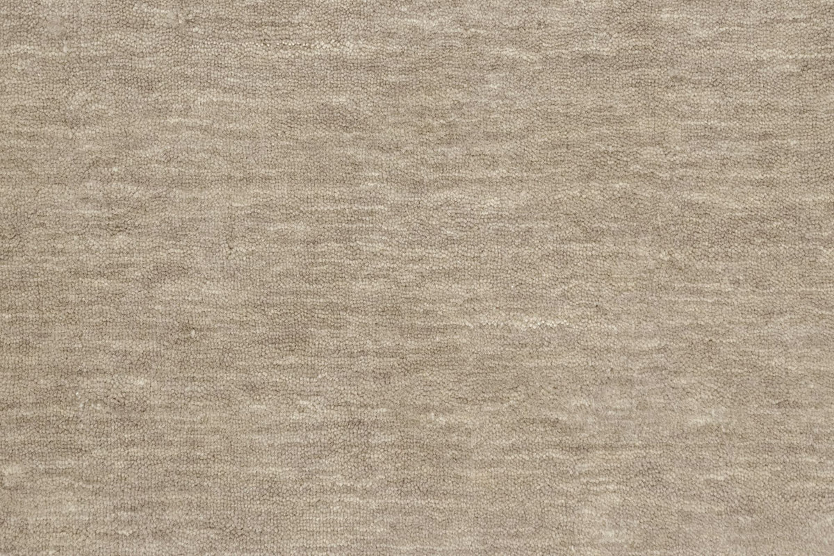 Grain Wool Rug in Mochaccino close up, a low, closely textured handloom New Zealand wool in a mottled warm grey.