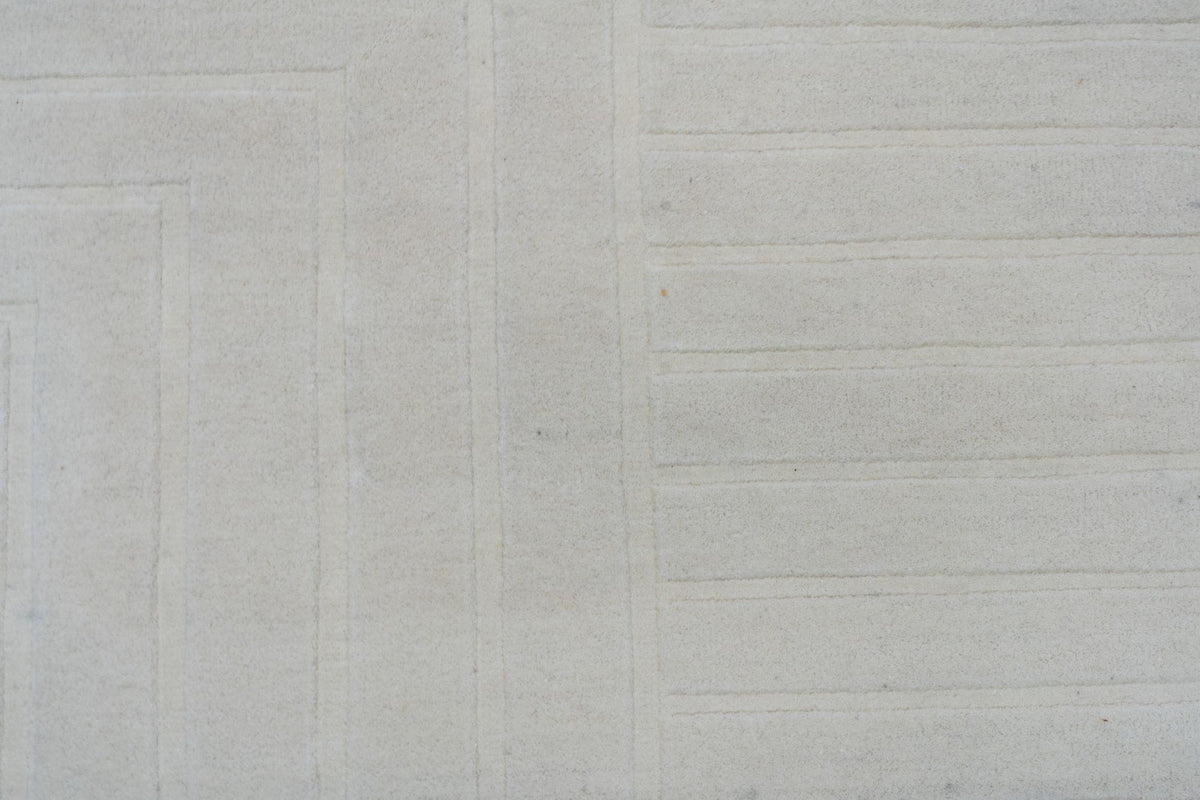 Liner Wool Rug close up, hand tufted cream New Zealand wool ruled in fine, even lines.