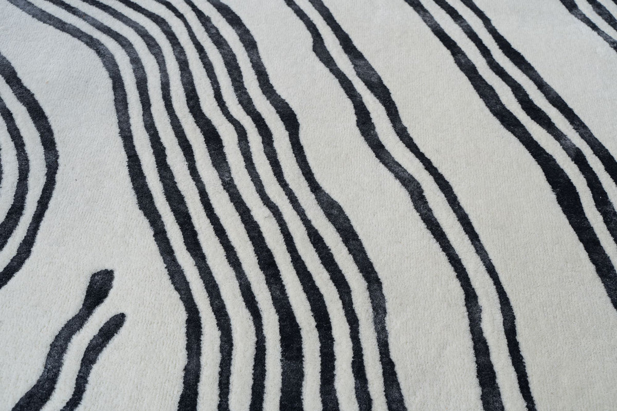 Livid Wool & Silk Rug close up, charcoal wavy lines in New Zealand wool and Botanical Silk on ivory.