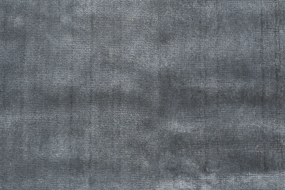 Luma Silk Rug in Charcoal close up, handloom Botanical Silk at 10 mm, a smooth, tight surface that releases dust easily.