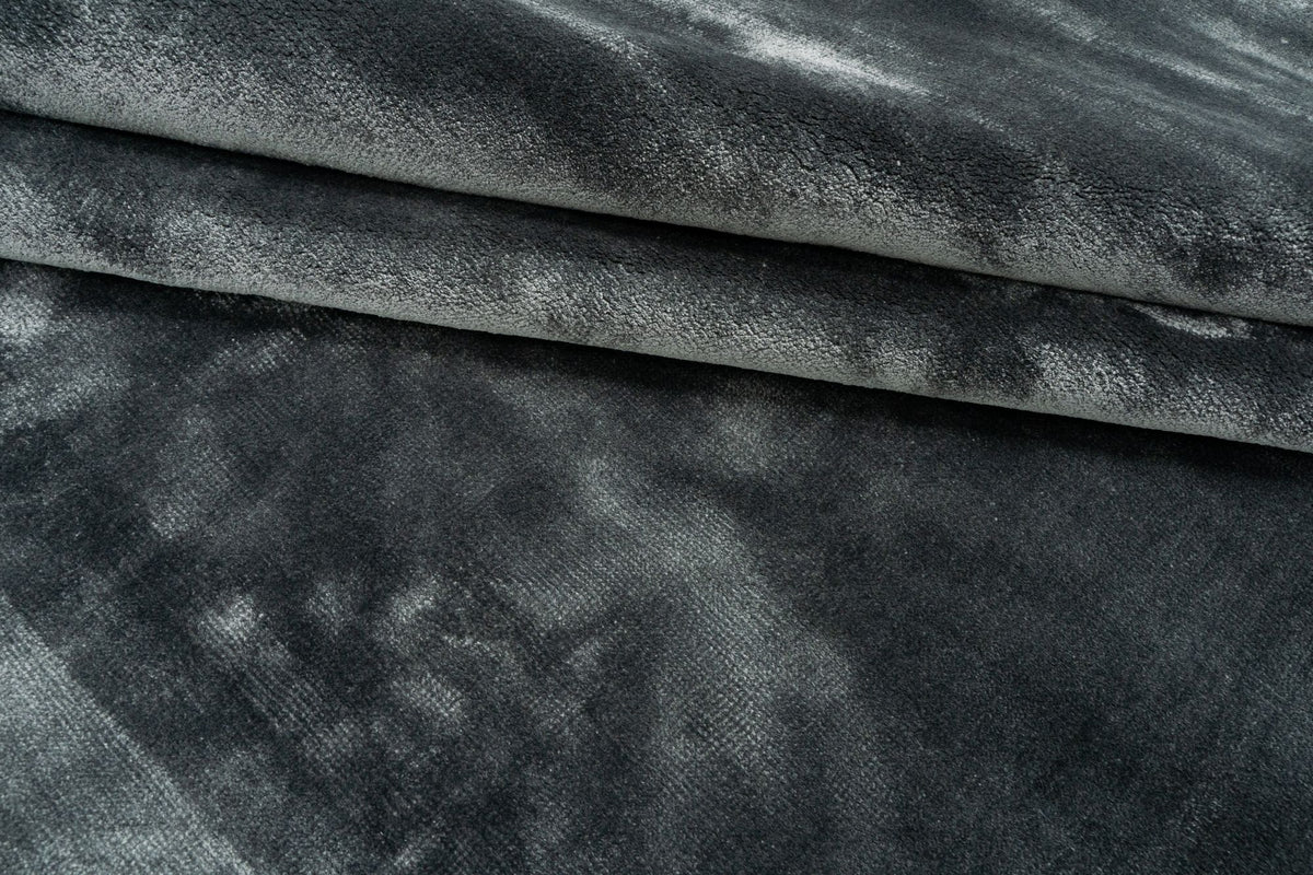 Luma Silk Rug in Charcoal, handloom Botanical Silk folded, the sheen changing across each fold.
