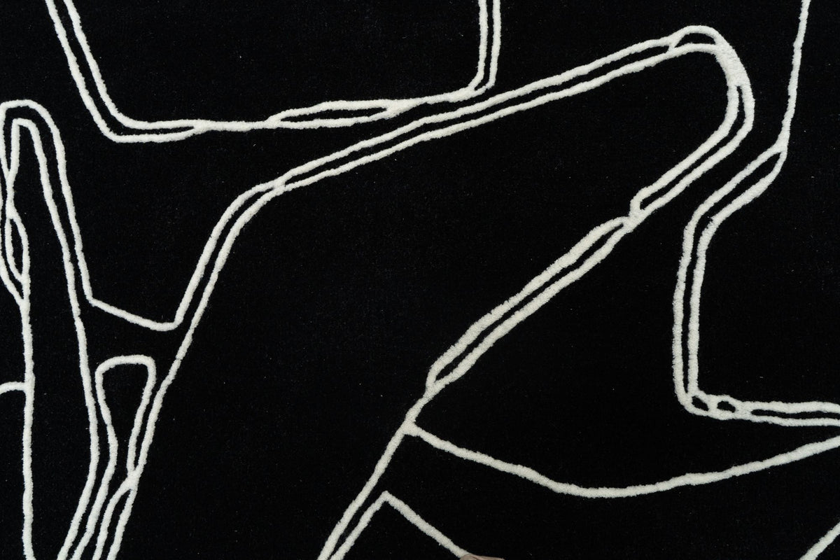 Mosaic Wool Rug close up, hand tufted New Zealand wool in black with fine ivory outlines.
