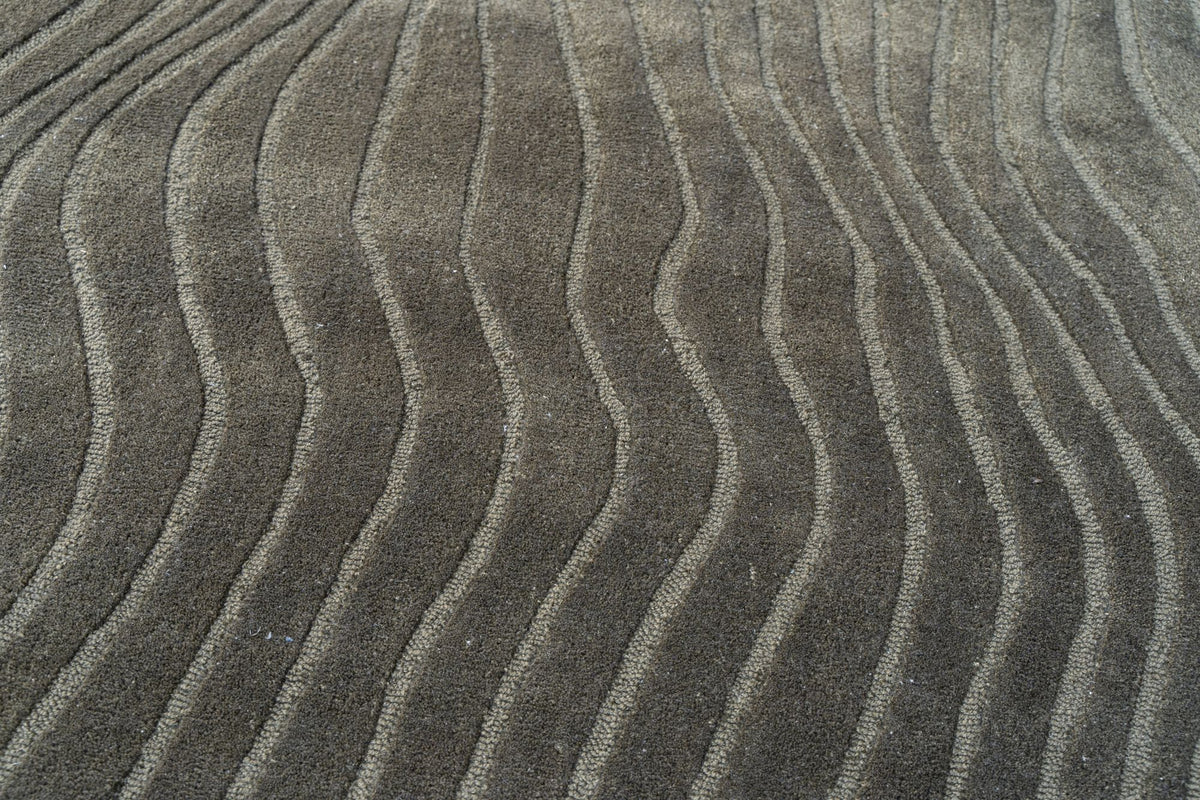Moss Wool Rug close up, hand tufted New Zealand wool in a soft grey green with ridges worked into the pile.