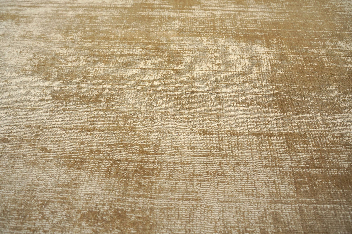 Nuva Silk Rug in Camel, the low handloom silk surface shifting from gold to cream.