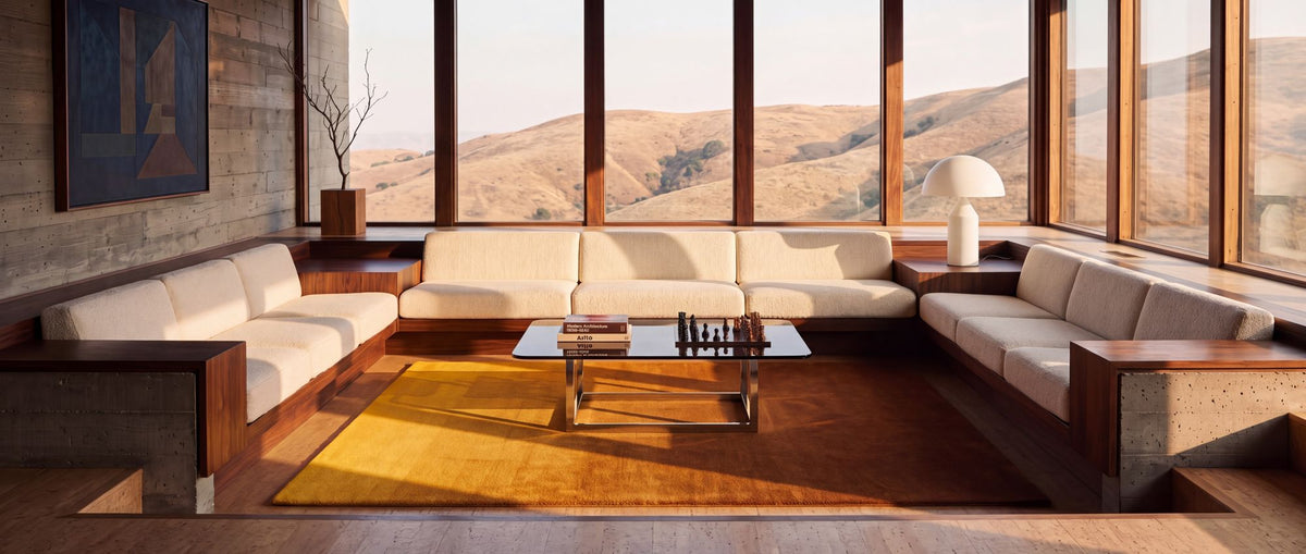 Ombré Pristine Rug in a conversation pit at golden hour, hand tufted New Zealand wool in warm yellow and amber.