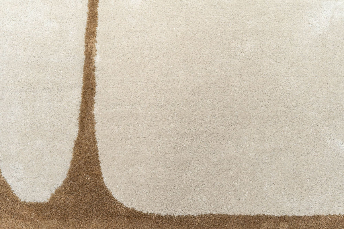 Outline Wool Rug close up, hand tufted New Zealand wool with a large ivory form on a warm tan ground.