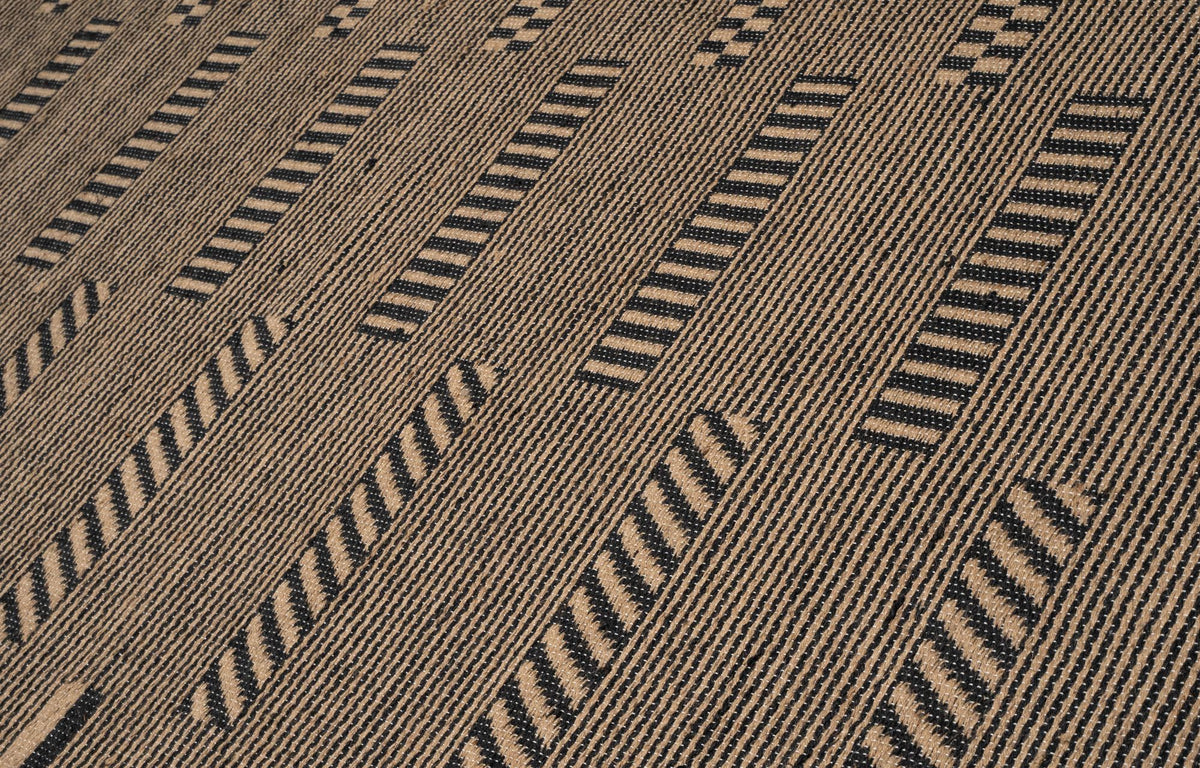 Pampas Jute Rug close up, hand woven jute in black and natural with diagonal blocks of fine stripes.