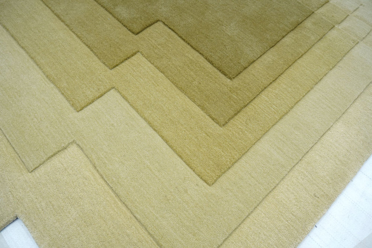 Talus Wool Rug at close range, straw deepening to moss, each tone carved apart by hand.
