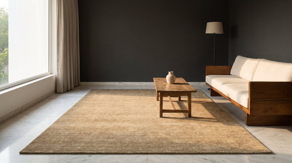 Grain Wool Rug in Tan in a styled apartment living room on a pale marble floor, handloom New Zealand wool.