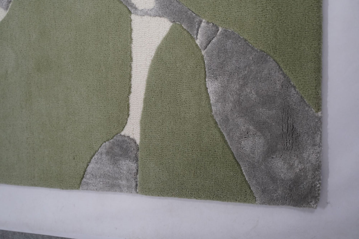Velocity Wool & Silk Rug close up, hand tufted New Zealand wool in sage with pale Botanical Silk forms.