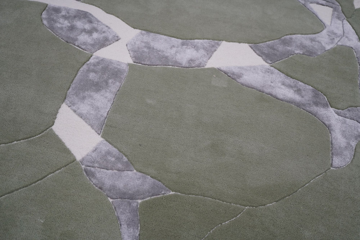 Velocity Wool & Silk Rug close up, sage New Zealand wool with grey Botanical Silk shapes and ivory outlines.