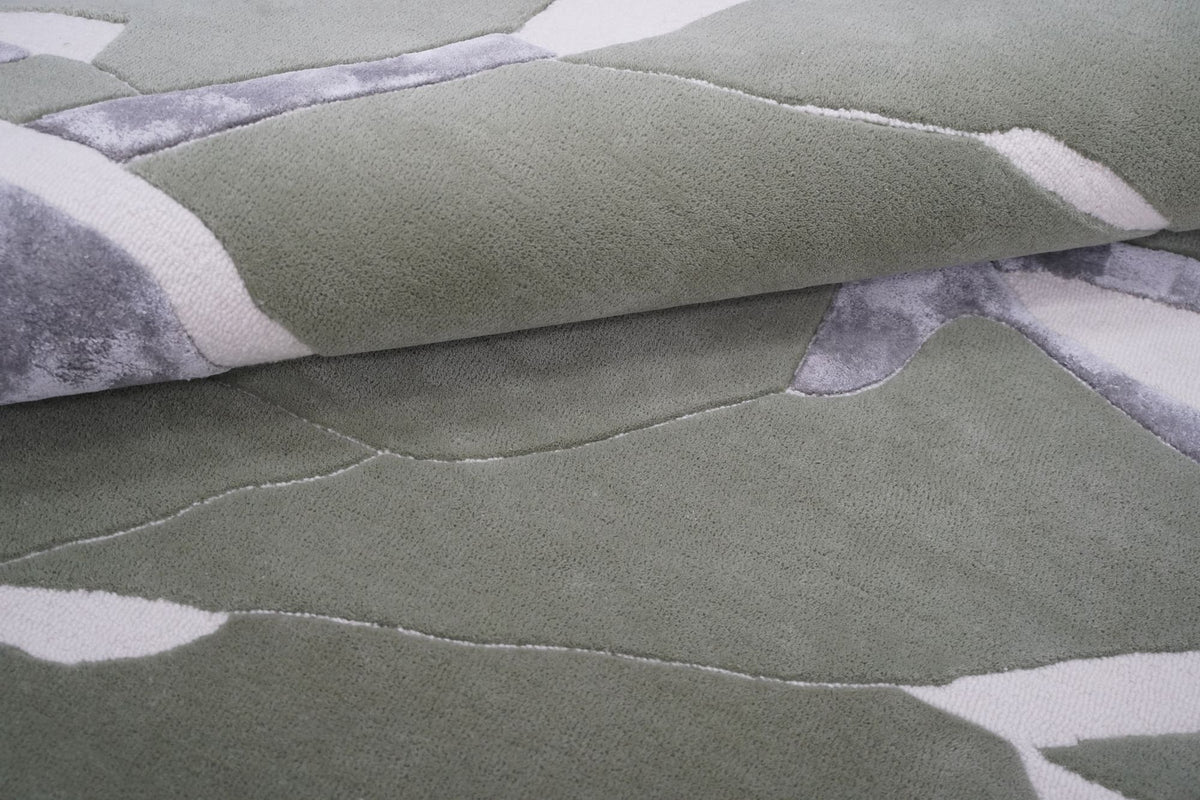 Velocity Wool & Silk Rug folded back, hand tufted New Zealand wool in sage green with grey strokes of Botanical Silk.