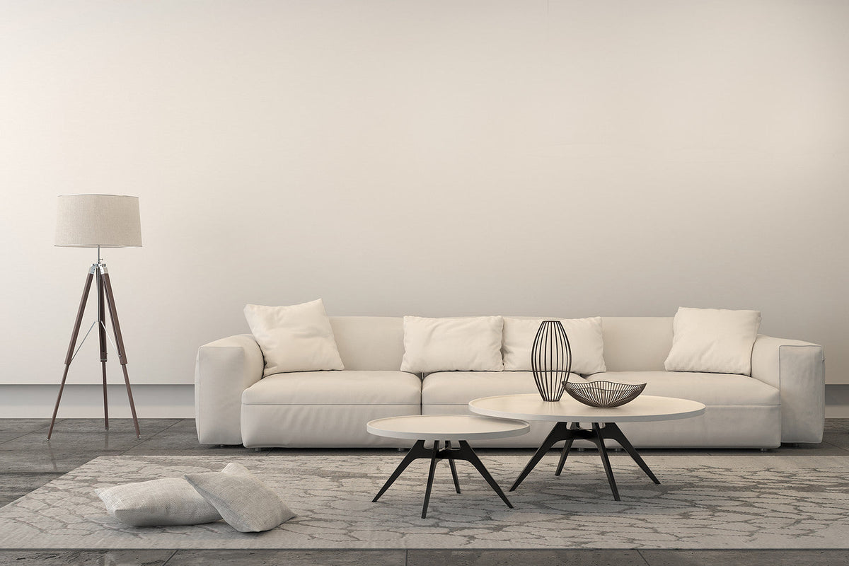 An all-white room with a piece of artwork as the focal point