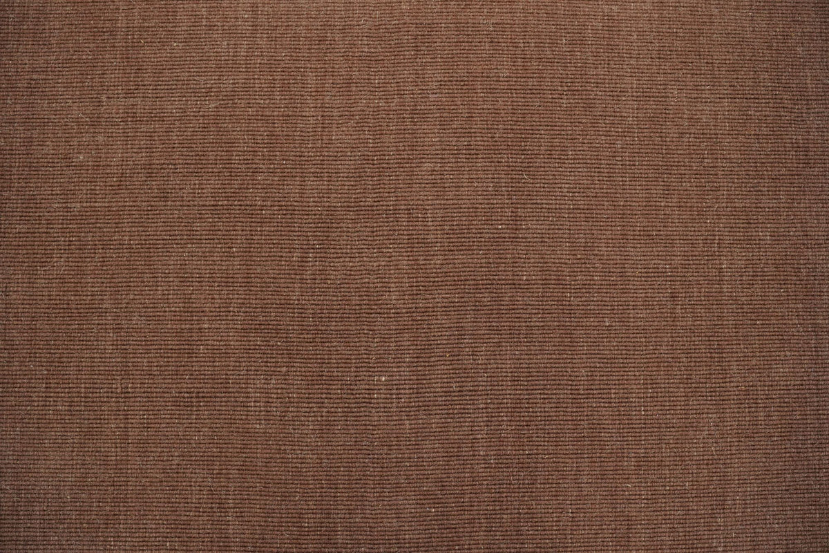Cabra Wool & Jute Rug in Rust close up, a flecked, earthy handloom weave that forgives daily life.