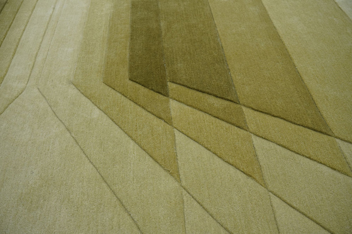 Cavea Wool Rug close up, hand tufted New Zealand wool in olive green carved into stepped layers.