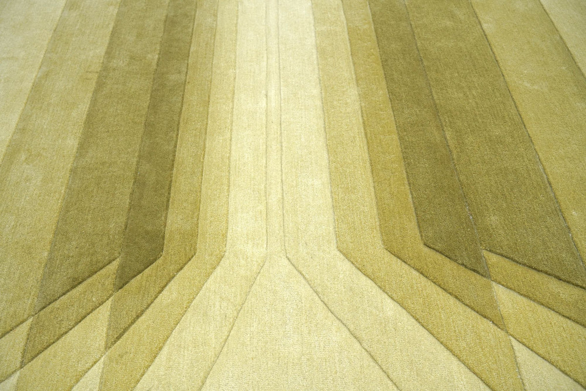 Cavea Wool Rug close up, hand tufted New Zealand wool carved into overlapping pale green planes.