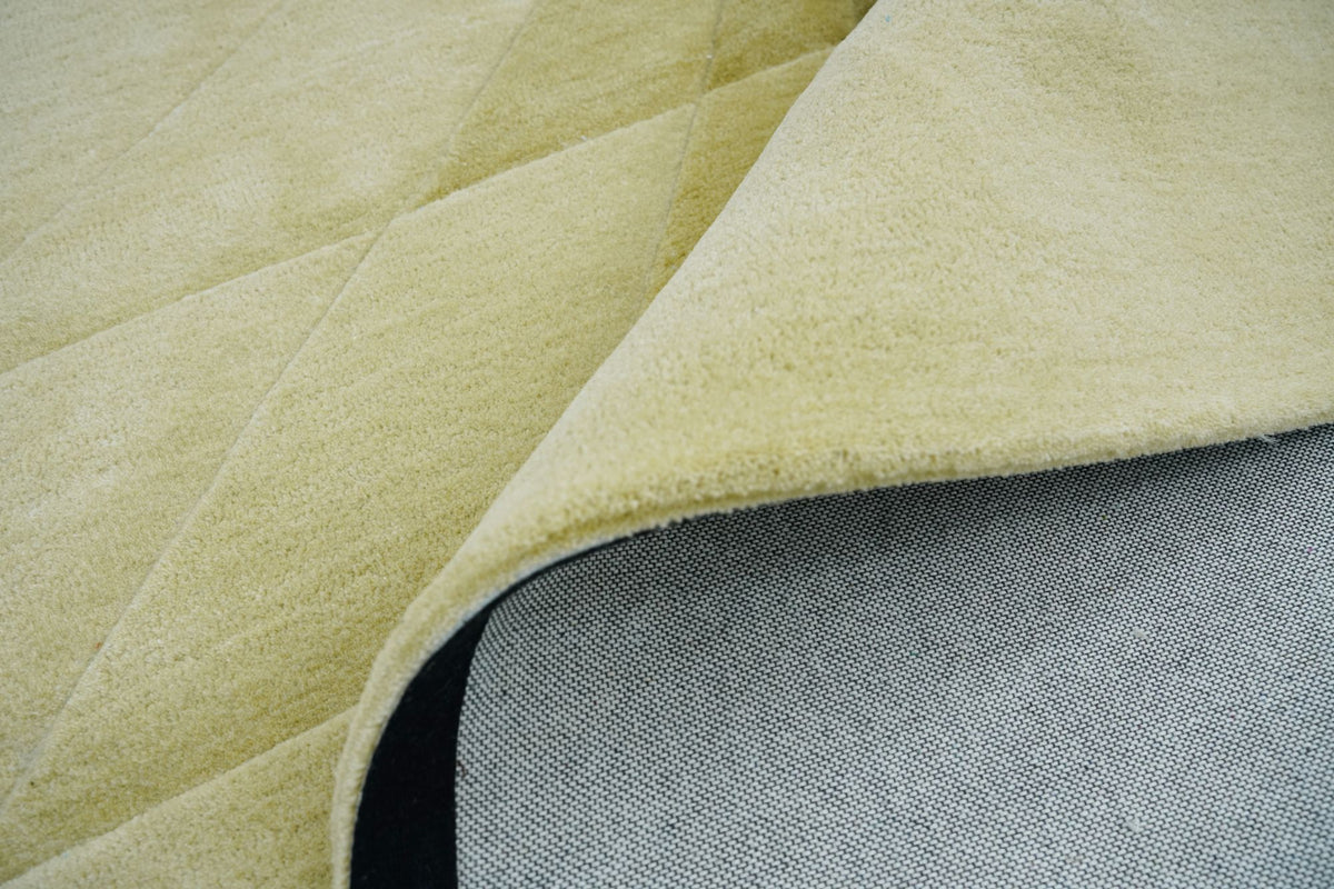 Cavea Wool Rug close up, a carved New Zealand wool surface in pale tones, photographed for comparison with the sculpted Marie Ducept pieces.