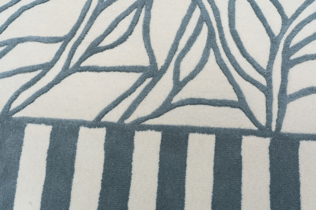 Euphoric Wool Rug close up, hand tufted ivory New Zealand wool with blue grey branching lines and stripes.