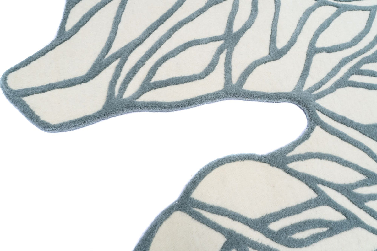 Euphoric Wool Rug close up, hand tufted ivory New Zealand wool drawn with loose teal grey lines to a free-form edge.