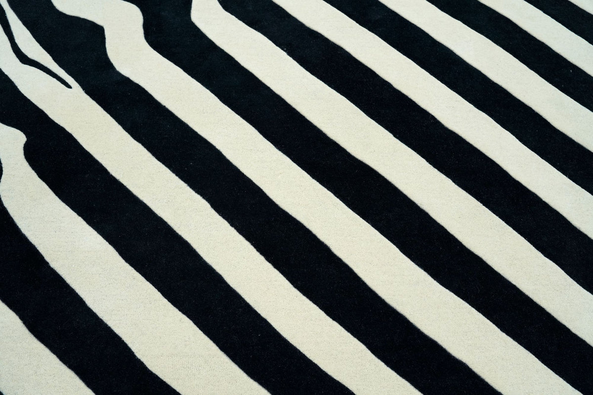 Fluid Wool Rug close up, bold black and ivory bands of hand tufted New Zealand wool pile.