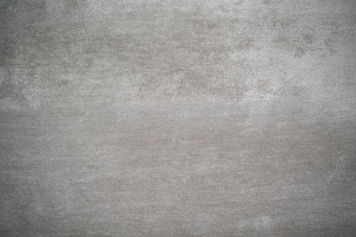 Luma Silk Rug in Gray, a real close up of silk catching light in soft clouds, the same quality of sheen the Abstract rug is built on.