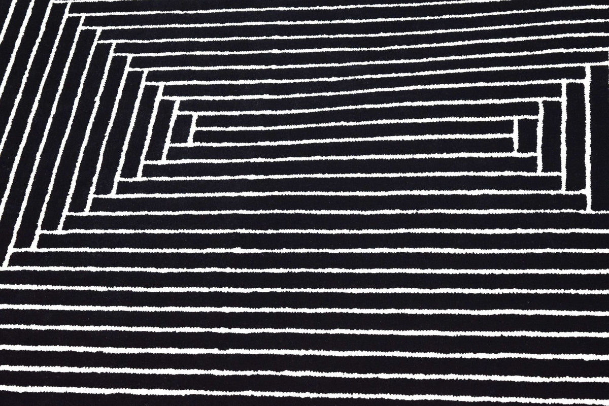 Noir Reversible Rug close up, hand woven in recycled and natural fibres, ivory lines on a black ground.
