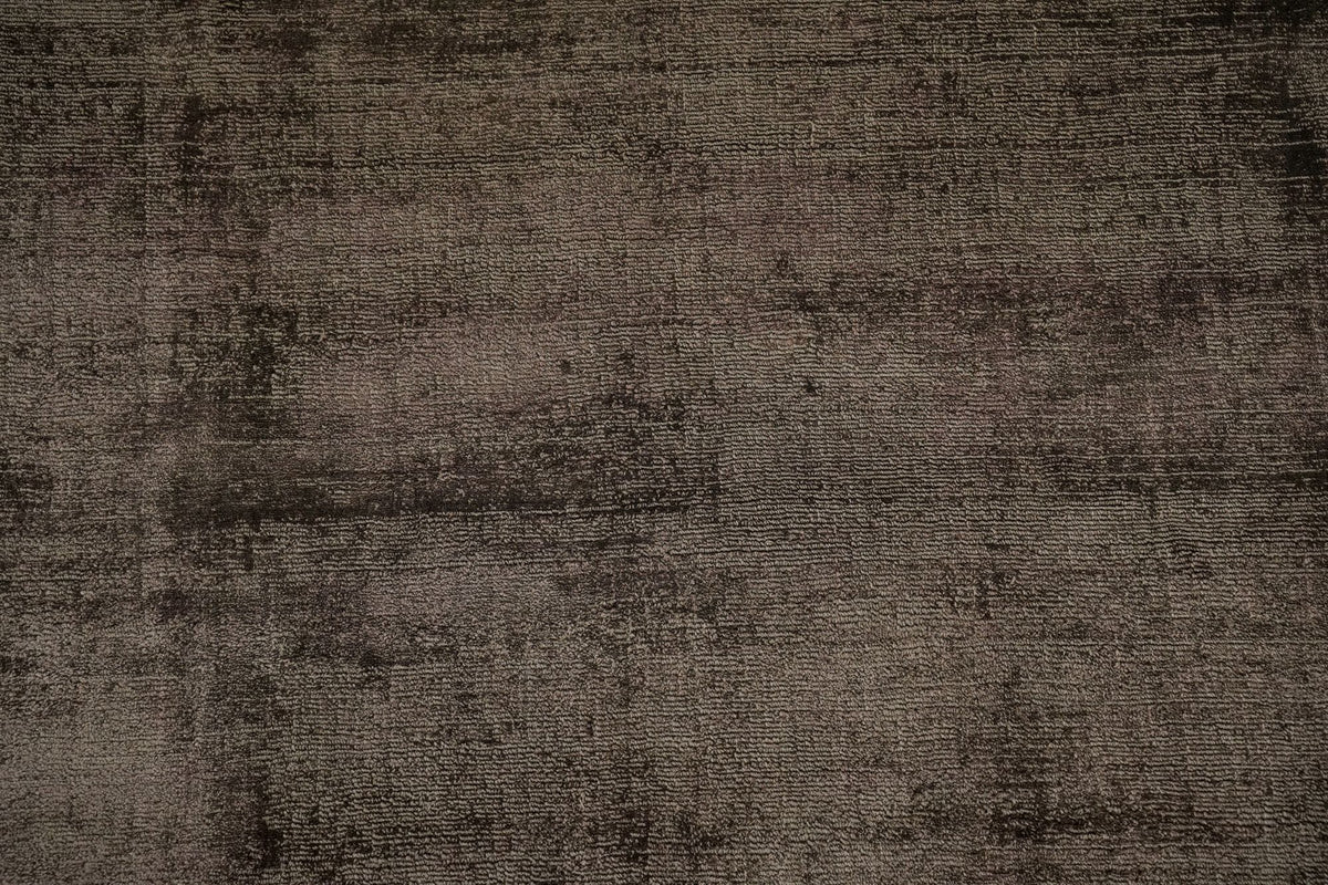 Nuva Silk Rug in Chocolate close up, handloom Botanical Silk with a low, shifting sheen across a dark brown surface.