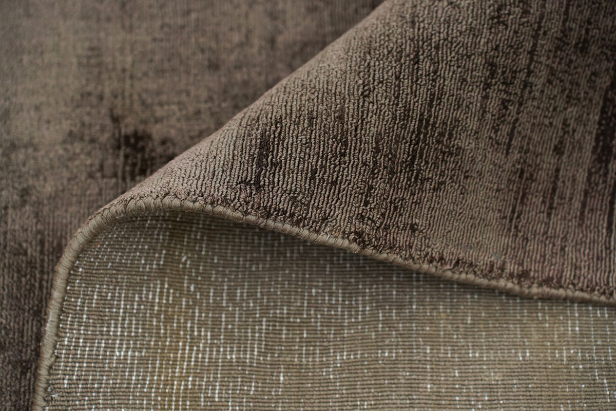 Nuva Silk Rug in Chocolate folded at the corner, handloom Botanical Silk with a deep brown sheen.