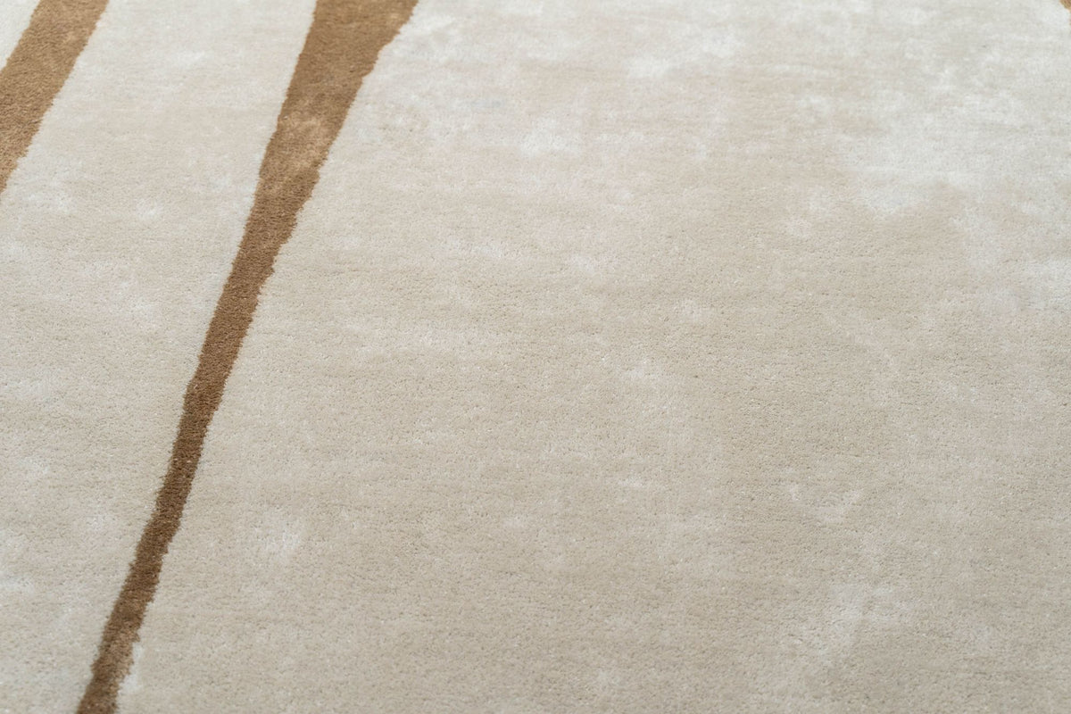 Outline Wool Rug close up, ivory hand tufted New Zealand wool with a single drawn line in tan.