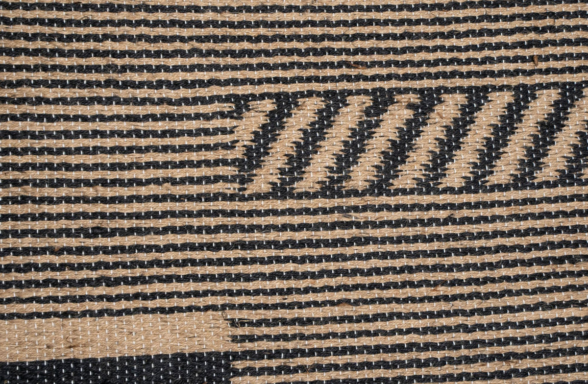 Pampas Jute Rug close up, a handwoven jute weave with black and natural diagonal bands.