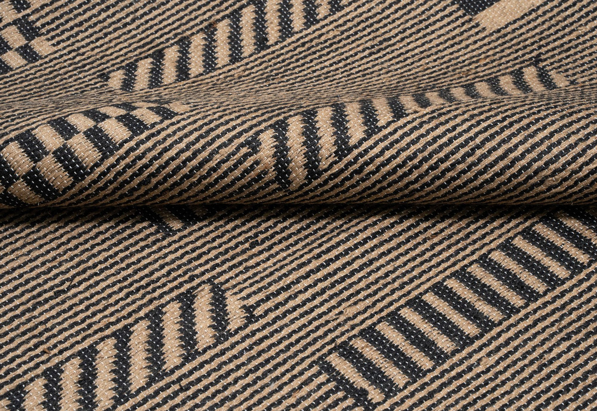 Pampas Jute Rug close up, a handwoven jute surface with diagonal bands in natural and black.