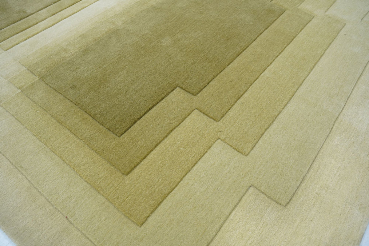 Talus Wool Rug close up, hand tufted New Zealand wool carved into stepped layers of soft moss and olive.