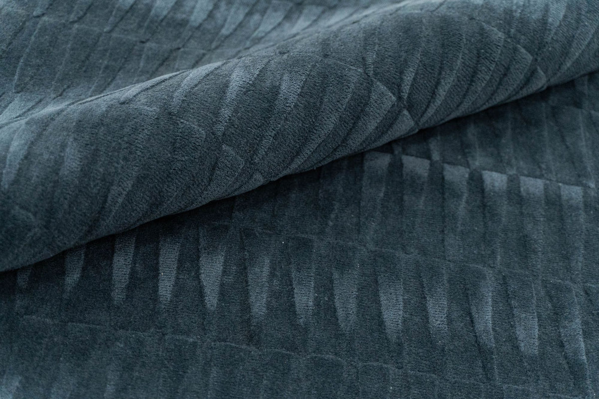 Teal Wool Rug folded, hand tufted New Zealand wool in a deep saturated teal with a carved surface.