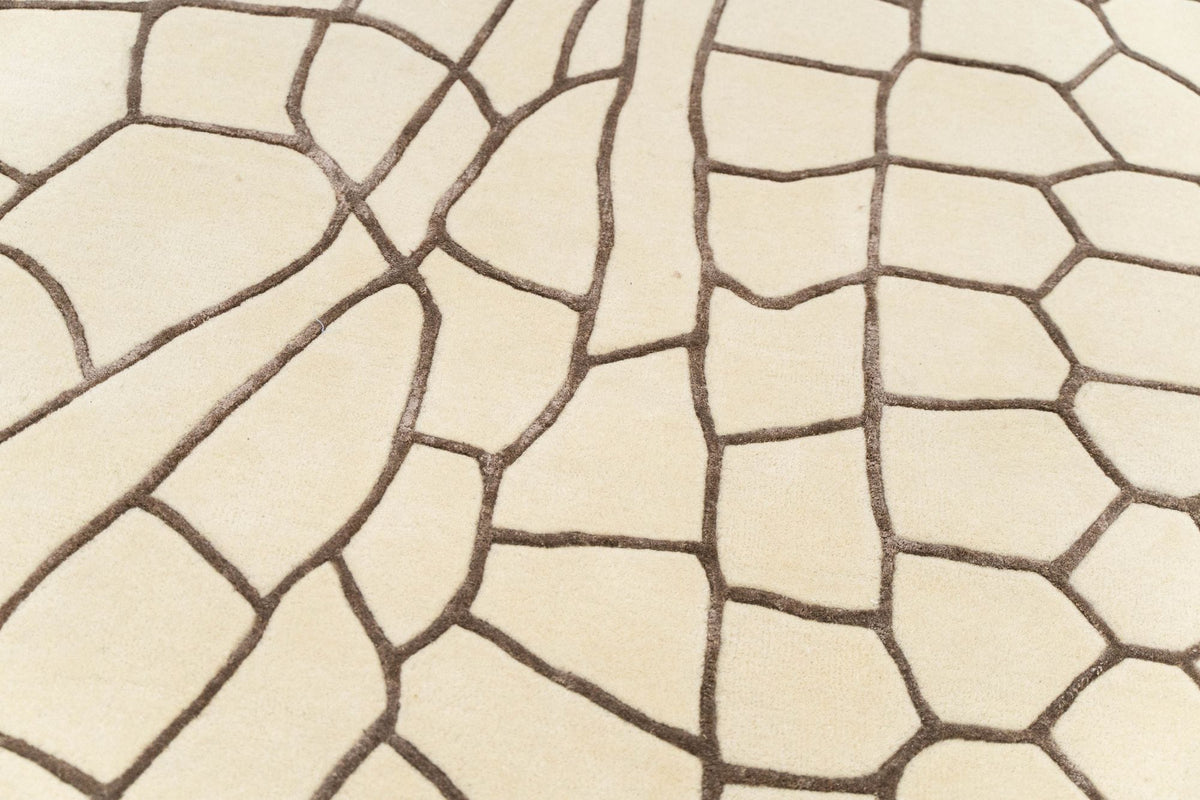 Terraform Wool & Silk Rug close up, hand tufted New Zealand wool and Botanical Silk, ivory planes divided by fine brown contour lines.