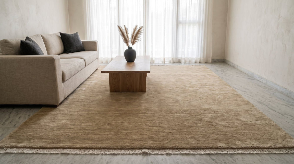 Grain Wool Rug in Sandstone in a styled living room render, handloom New Zealand wool in a warm earthen beige.