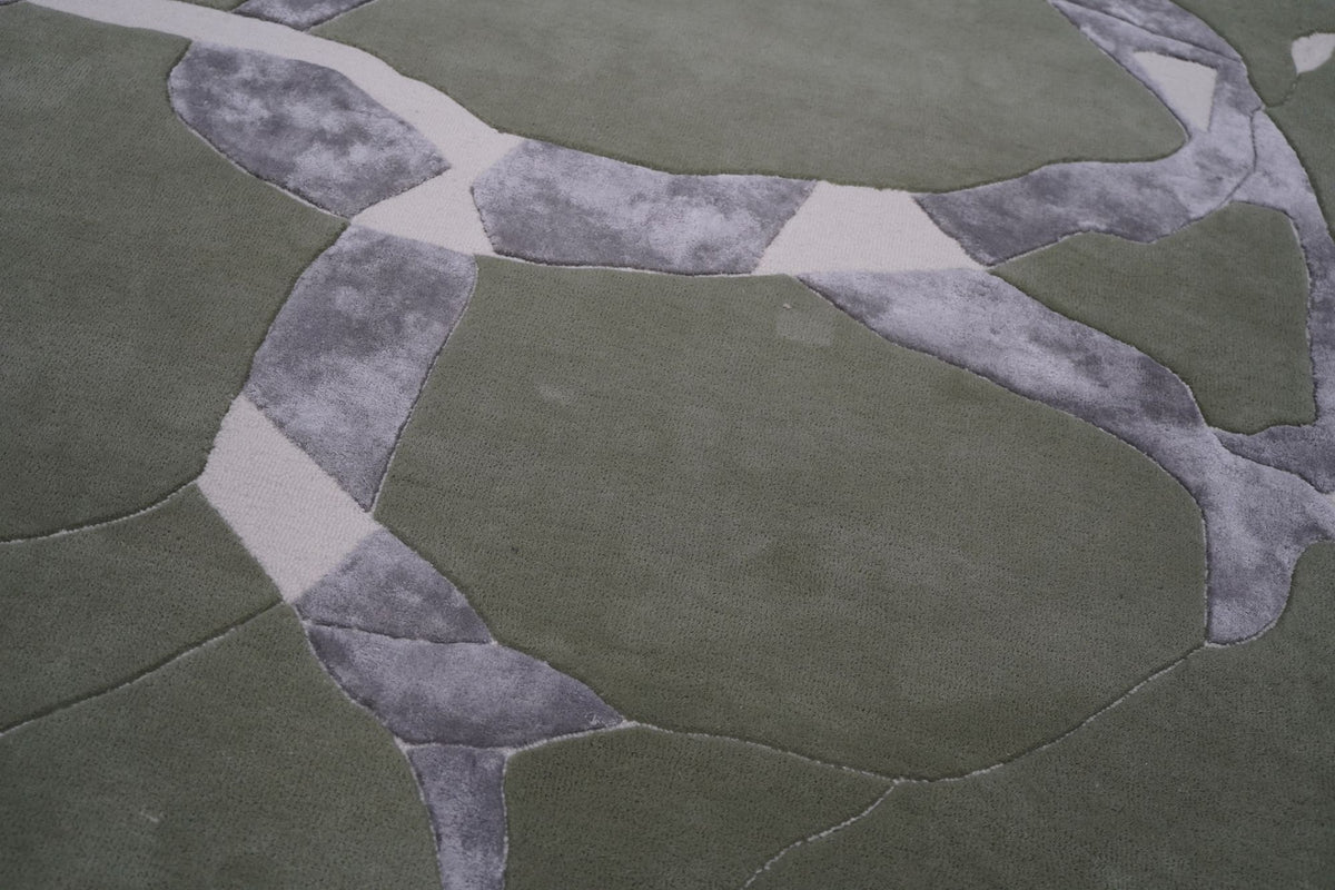 Velocity Wool & Silk Rug close up, sage and grey planes with pale drawn lines in hand tufted New Zealand wool and Botanical Silk.